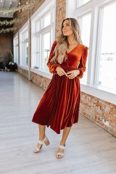 Indulge in the luxurious comfort and style of our Autumn Vibes Smocked Velvet Dress! This elegant wrap dress, made from sumptuous velvet, features smocked detailing at the waist for a flattering fit. Perfect for any occasion from fancy dinners to casual nights out. Embrace the season with a stunning rust color and midi length. Fall has arrived, time to bring out the velvet! The Deets: Fit: Midi Material: 95% POLYESTER +5% ELASTANE Brand: Liam & Company Measurements: 45" long, 13" bust Model: wea Elegant Wrap Dress, Fancy Dinners, Casual Night Out, Autumn Vibes, Plus Size Pants, Rust Color, Matching Dresses, Velvet Dress, Plus Size Tops