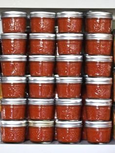 many jars of food are stacked on top of each other in front of a shelf