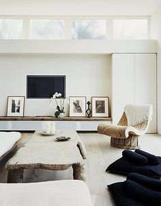 a living room filled with furniture and pictures on the wall