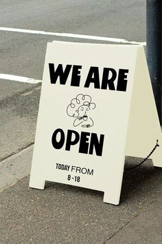 a sign on the sidewalk that says we are open today from 8 - 18pm