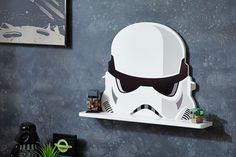 a star wars themed wall mounted shelf with a storm trooper mask on it's face