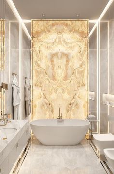 a bathroom with marble walls and flooring, white bathtub next to two sinks