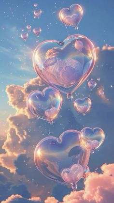 some soap bubbles floating in the air with heart shaped bubbles flying around them on a cloudy blue sky