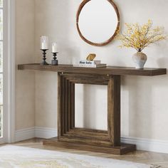 a wooden table with a mirror and vase on top