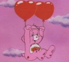 a pink teddy bear holding two red heart balloons in the air with clouds behind it