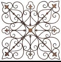 an iron wall decoration with leaves and scrolls