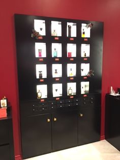 a room with red walls and black cabinets