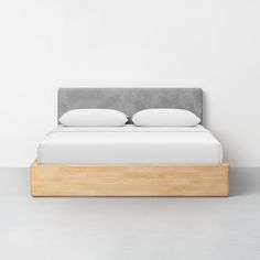 a bed with two pillows on top of it