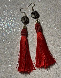 Elevate your everyday ensemble with these enchanting embellished Red Tassel Earrings. Crafted with a harmonious blend of gold, black, and red hues, each tassel exudes sophistication and charm. The intricate design effortlessly merges casual elegance with timeless style, making them the perfect accessory for any occasion. Finished with alloy fish hook closures, these earrings offer both comfort and flair, ensuring you shine with every step you take. Every Step You Take, Casual Elegance, Fish Hook, Tassel Earrings, Gold Black, Favorite Jewelry, Jewelry Earrings Dangle, Timeless Fashion, Etsy Earrings