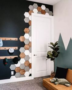 a living room decorated with hexagonal tiles and wood accents, including a couch