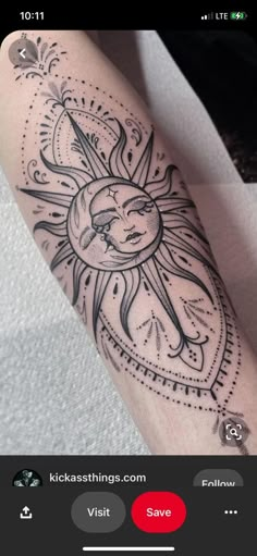 a sun and moon tattoo on someone's arm with an arrow in the middle