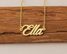 "Name Necklace, Personalized Necklaces for Women, Engraved Necklace, Tiny Necklace Christmas Gift for Ella This necklace is made of Stainless Steel Available color: Gold, Silver and Rose Gold Chain Length: 14\"16\"18\"20\"22\" inches Processing Time: 2-10 business days Standard Shipping: 10-15 business days to USA. 15-30 business days to other countries. Expedited Shipping: 5-8 business days to USA. 5-10 business days to others. Please do not hesitate to contact us with any concerns." Gold Engraved Necklace For Christmas, Personalized Gold Charm Necklaces For Christmas, Custom Name Gold Necklace For Christmas, Personalized Gold Charm Necklace For Christmas, Gold Nameplate Necklace For Christmas, Gold Christmas Necklace With Name Detail, Gold Necklace With Name For Christmas, Christmas Gift Nameplate Necklace, Gold Name Necklace For Christmas