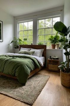 a bedroom with a bed, plants and pictures on the wall