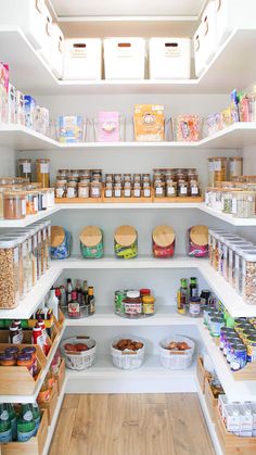 an organized pantry with lots of food and snacks on shelves, including breads, cereals, nuts, and other items