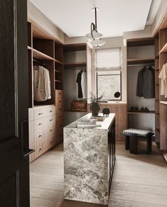 a large walk in closet with marble counter top