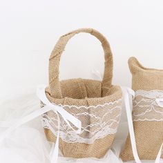 two burlap baskets with white lace on them