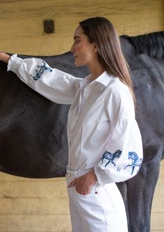 Introducing our new Annie shirt, a classic addition with an equestrian touch. Delicate horse embroidery graces the sleeves of this crisp white button-down, adding a hint of charm. Smocked details on the cuffs enhance its refined appeal, making it a perfect choice for equestrian-inspired looks. With upgraded lantern sleeves, it's both fun and elegant, catering to the modern equestrian enthusiast. Perfect for adding a whimsical touch to your wardrobe or riding ensemble. Don't miss out on the re-la Elegant Catering, Modern Equestrian, Horse Embroidery, Summer Sleepwear, Velvet Loafers, White Button Down, Cap Hair, Lantern Sleeves, Embroidered Shirt