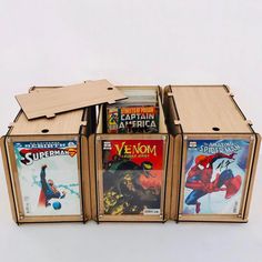 four wooden boxes filled with comic books on top of each other in front of a white background