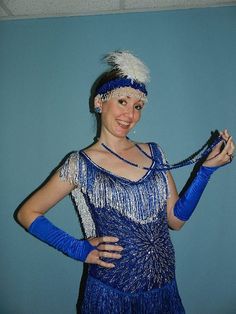 This beautiful royal blue beaded flapper dress is accented with blue & metallic fringe to match the lovely beaded pattern of front of dress.  The 1920’s redesign would be appropriate for any Gatsby or Downton Abbey party with the heart shaped neckline with an open back.  I have added a fringed strap in the back with hooks to keep the shoulders straps up.  The dress has a back zipper, stylish leg opening in front and several layers of fringe to the hem.  In the 1920’s it was appropriate to co Fitted Flapper Dress With Beaded Fringe For Costume Party, Fitted Beaded Fringe Flapper Dress For Costume Party, Summer Beaded Fringe Flapper Dress, Fitted Blue Flapper Dress, Fitted Blue Dress With Beaded Fringe, Blue Flapper Dress 1920s, Sleeveless Beaded Fringe Flapper Dress, Downton Abbey Party, Style Party Dress