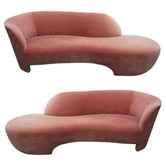 two pink couches sitting next to each other