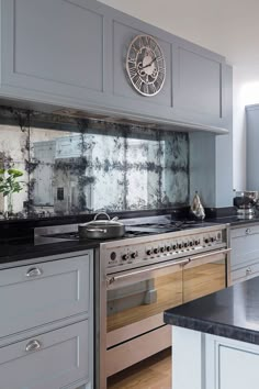 a kitchen with an oven, stove and counter tops in grey tones is pictured here