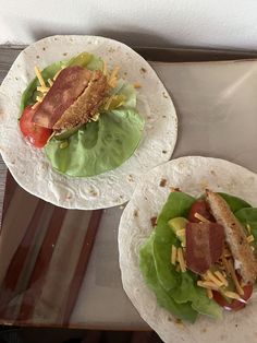 two tortillas with lettuce and bacon on them