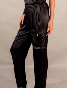 Ciara Cargo Pant, a stylish and sophisticated take on the classic cargo pant. Made from silky stretch satin, this pant feels smooth and luxurious to the touch, while also providing a flattering and comfortable fit. The Ciara Cargo Pant features four pockets, two of which have button closures, providing both functionality and style. The cargo pant design adds a touch of edginess to the overall look, while the silky fabric provides a sophisticated and polished finish. The versatile design of the C Classic Blouses, Simple Tshirt, Cargo Pant, Stretch Satin, Pants Design, Casual Style, Overalls, Comfort Fit, Satin