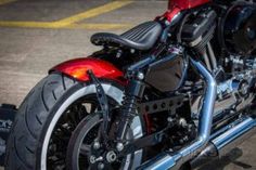 a red and black motorcycle parked in a parking lot