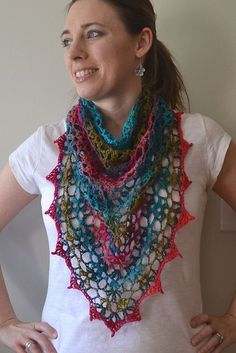 a woman wearing a multicolored crocheted scarf