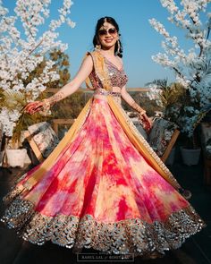 a woman in a colorful dress posing for the camera