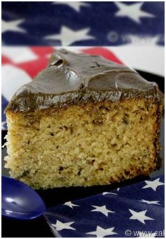 a piece of cake sitting on top of a plate next to a blue and white flag