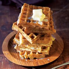 a stack of waffles with butter on top