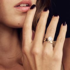 a close up of a person with a ring on their finger and holding a cell phone