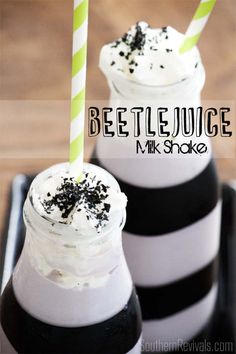 two drinks with whipped cream and blackberries in them, on a tray that says beetlejuice mr shake