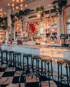 the bar is decorated for christmas with wreaths