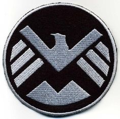 an eagle patch is shown on a white surface with black and grey trimmings