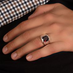 Unleash your inner style icon with our Ruby Silver Ring, a bold and striking jewelry masterpiece. At MyJewelist, we are here to redefine your style, offering you a unique piece that reflects your individuality and adds a touch of cool sophistication to your look. Our Ruby Silver Ring isn't just an accessory; it's a reflection of your distinctive style. When you wear it, you'll radiate confidence and charm, effortlessly grabbing attention wherever you go. ० UNMATCHED COMFORT, IMPECCABLE STYLE ० Concerned about comfort? No worries! Our jewelry is meticulously designed with your comfort in mind. We exclusively use hypoallergenic, nickel-free materials, ensuring you look and feel your absolute best. ० DETAILS ० ★CRAFTED TO PERFECTION: The Ring is a testament to precision and craftsmanship, met Luxury Red Men's Ring As Gift, Modern Red Open Ring, Modern Red Ring Jewelry, Modern Red Ruby Ring, Modern Ruby Promise Ring With Polished Finish, Modern Red Ring For Formal Occasions, Modern Red Rings For Formal Occasions, Minimalist Red Rings For Formal Occasions, Modern Ruby Open Ring For Gift