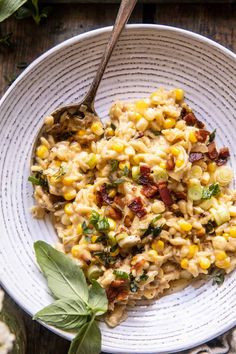 a white bowl filled with macaroni and cheese on top of a wooden table