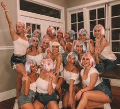 a group of women with pink hair posing for a photo