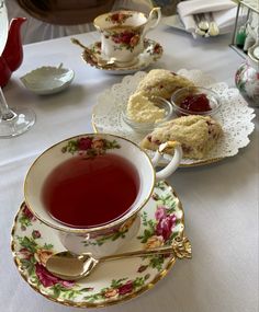 a table topped with plates and cups filled with tea