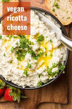 vegan ricotta cheese in a bowl with bread and strawberries on the side