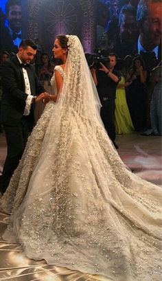 the bride and groom are standing in front of an audience at their wedding ceremony, which is being shared on instagram