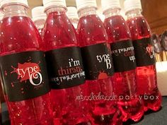 several bottles of red liquid sitting on top of a table