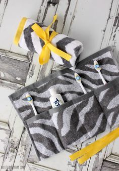 two zebra print towels with toothbrushes in the middle and yellow ribbon around them