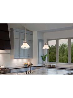 a kitchen with two lights hanging from the ceiling