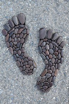 two footprints made out of rocks on the ground