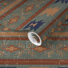 an artistic wallpaper with native american designs on it's surface, including a roll of tape