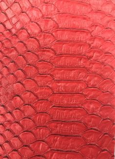 red leather textured up close to the surface with an animal print pattern on it