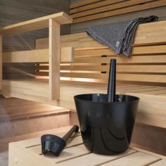 a black cup sitting on top of a wooden table