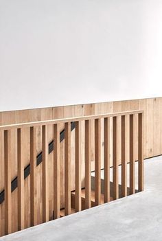 an empty room with wooden slats on the wall